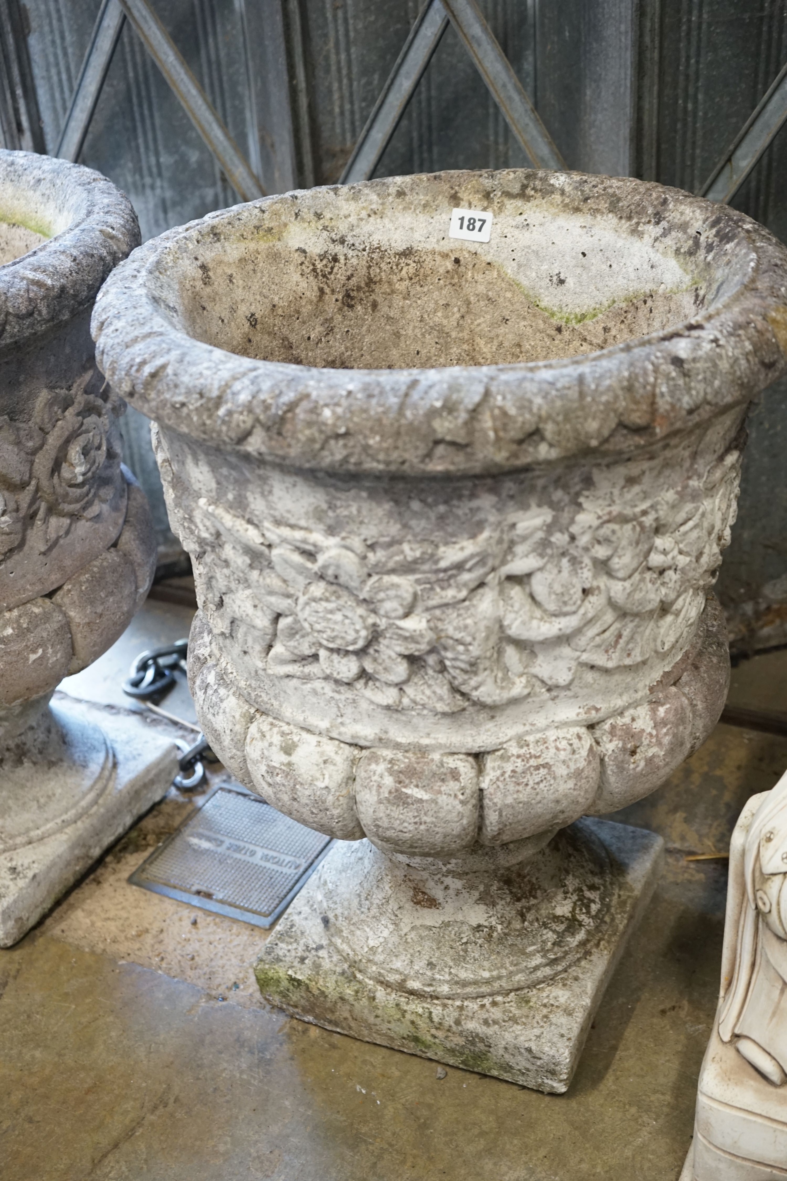 A pair of reconstituted stone campana garden urns, diameter 46cm height 60cm